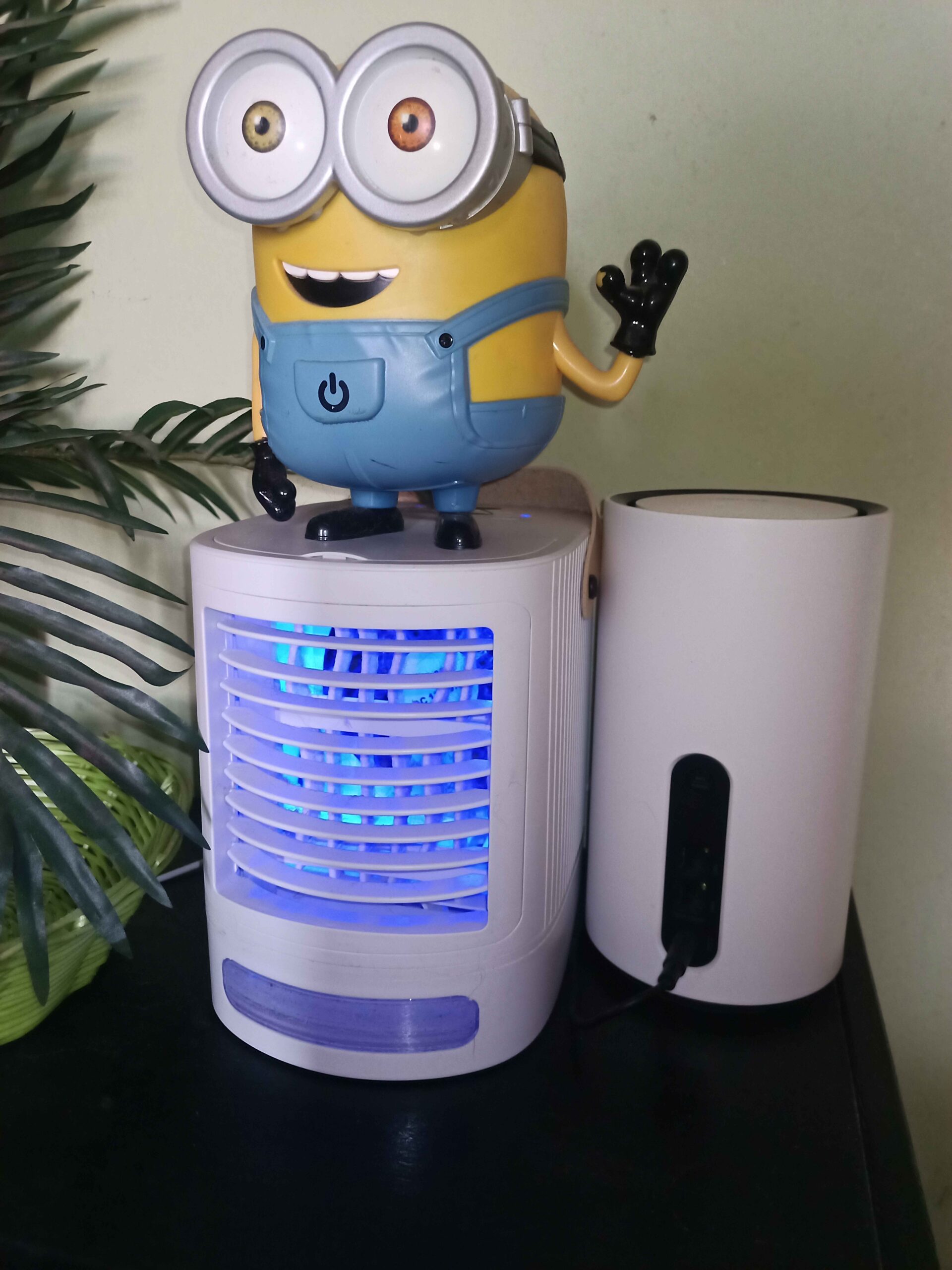 Kompakter, mobiler Luftkühler mit Minions-Lampe und Router auf einer Kommode